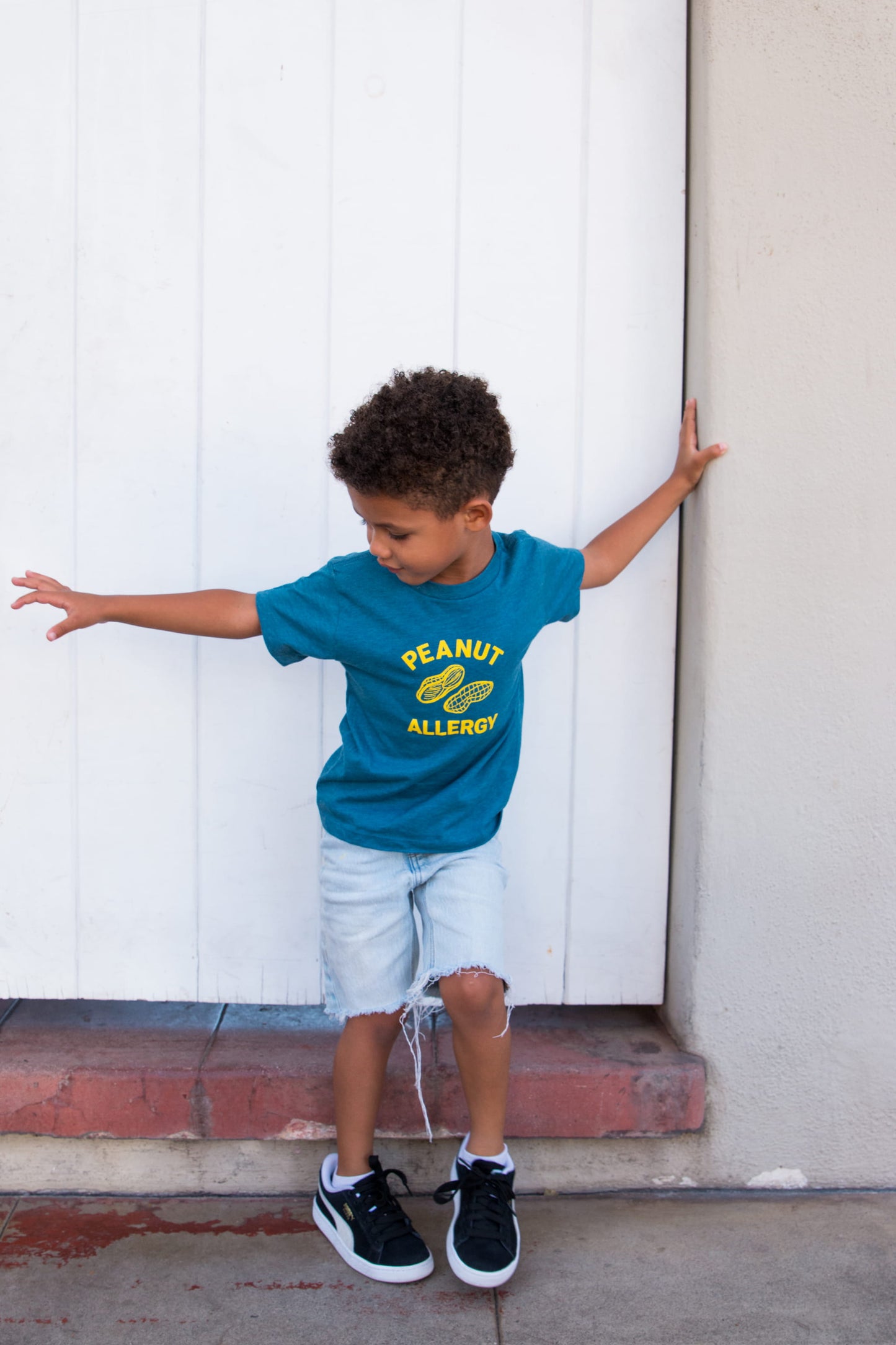 boy wearing teal graphic peanut allergy t-shirt