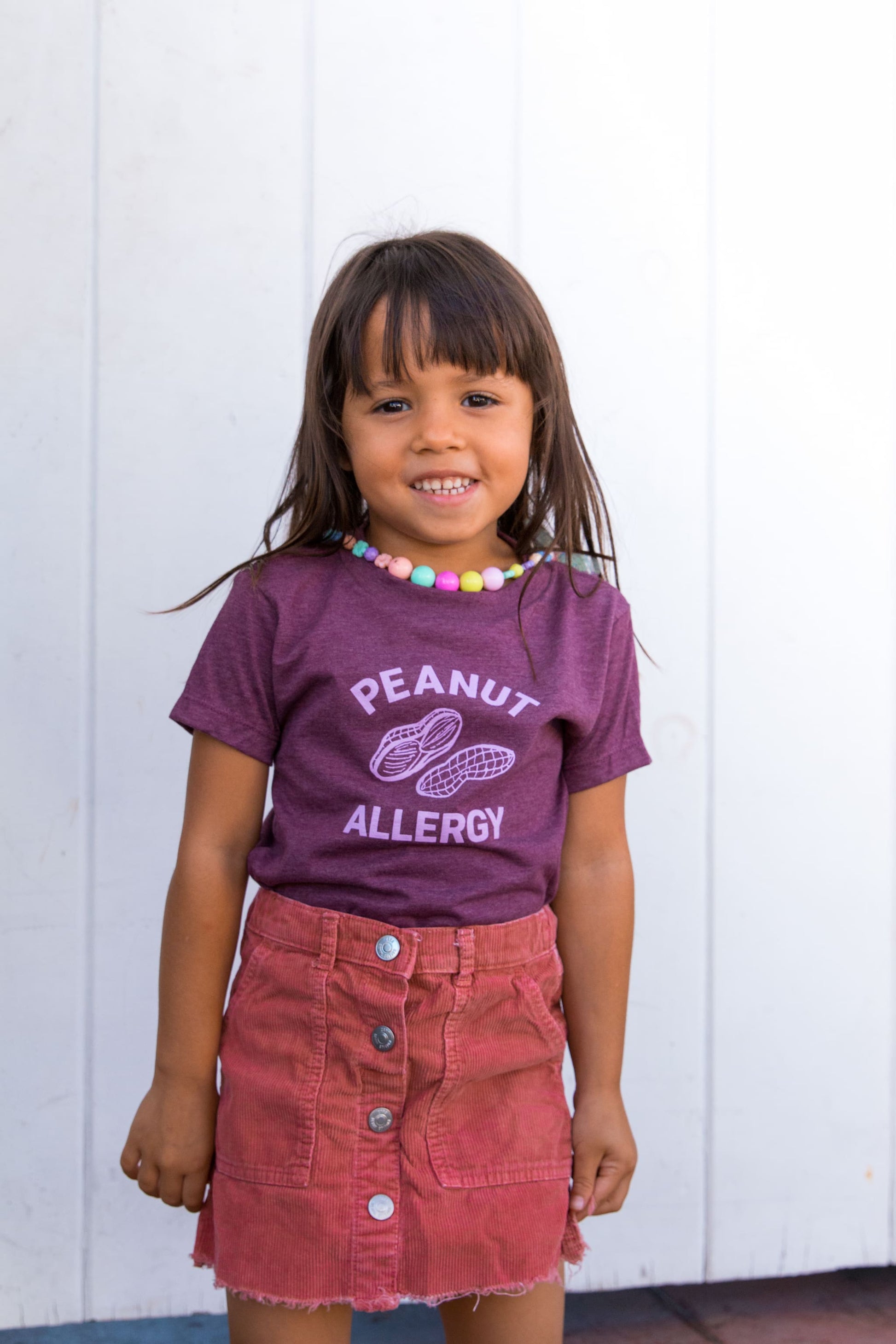 girl in maroon peanut allergy graphic t-shirt